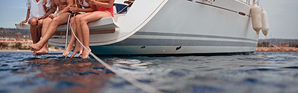 People sitting on boat feet in water