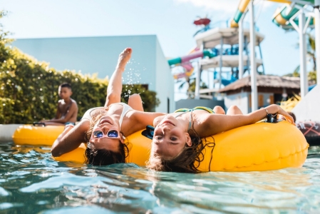 women on intertubes in pool