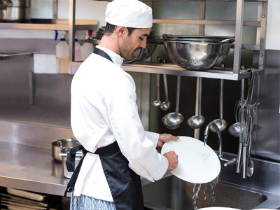 Chef washing dishes in sink; Adobe Stock: 108023395