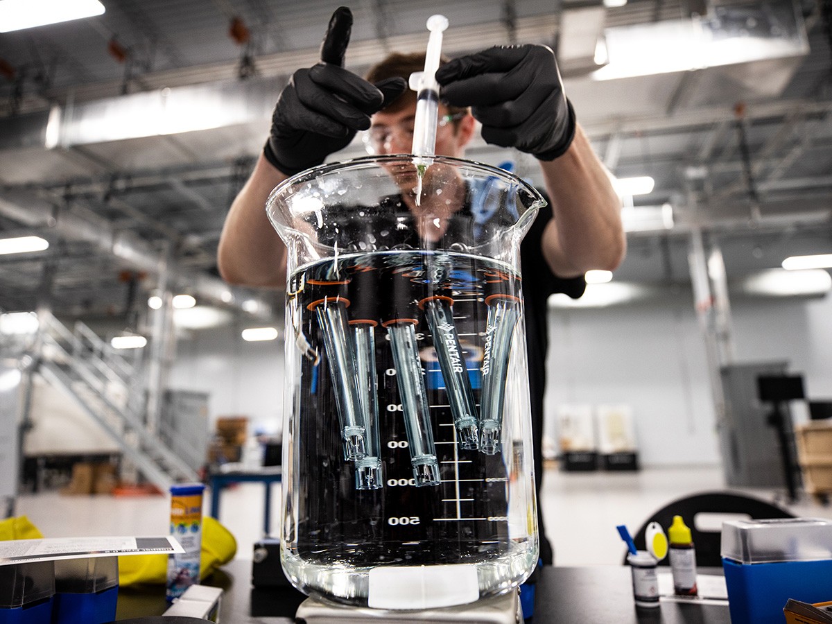 Pentair Employee Working in Lab Employee testing water sensors in the Apex innovation lab