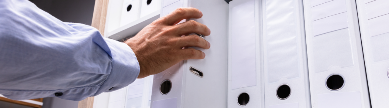 P14352 pulling white binder off shelf web 1440x400
